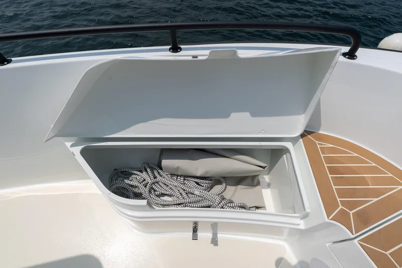 Stock 6 Yacht Photos Pics Open storage compartment on 2026 Targa 32 GT boat, containing rope and cover.