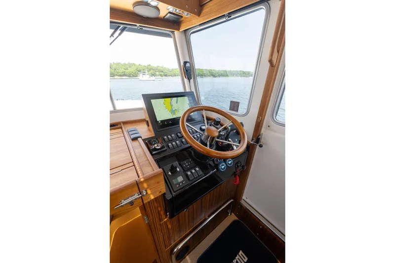 Stock 6 Yacht Photos Pics Helm of 2026 Targa 32 GT boat with navigation screen and wooden steering wheel.