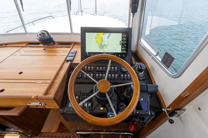 Stock 6 Yacht Photos Pics Helm of 2026 Targa 32 GT boat with navigation display and wooden steering wheel.