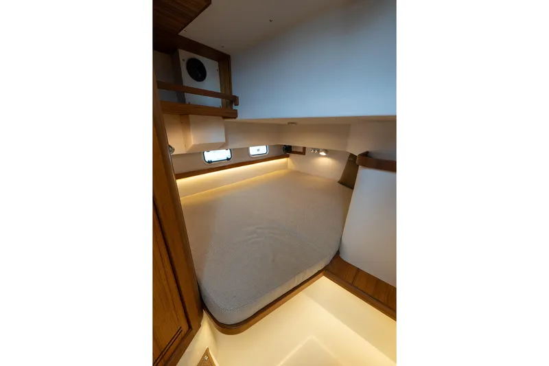 Stock 6 Yacht Photos Pics 2026 Targa 32 GT cabin interior with cozy bed and ambient lighting.