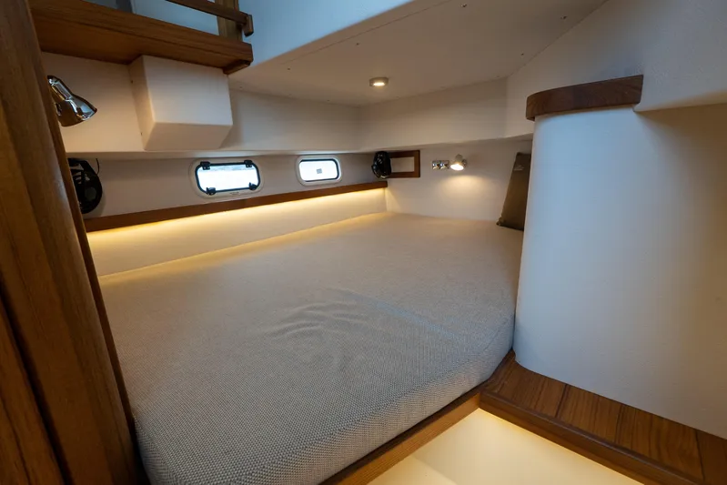 Stock 6 Yacht Photos Pics Luxurious cabin interior of 2026 Targa 32 GT boat with cozy bedding and ambient lighting.