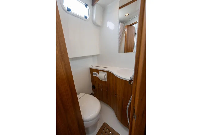Stock 6 Yacht Photos Pics 2026 Targa 32 GT yacht bathroom with wooden cabinetry and modern fixtures.