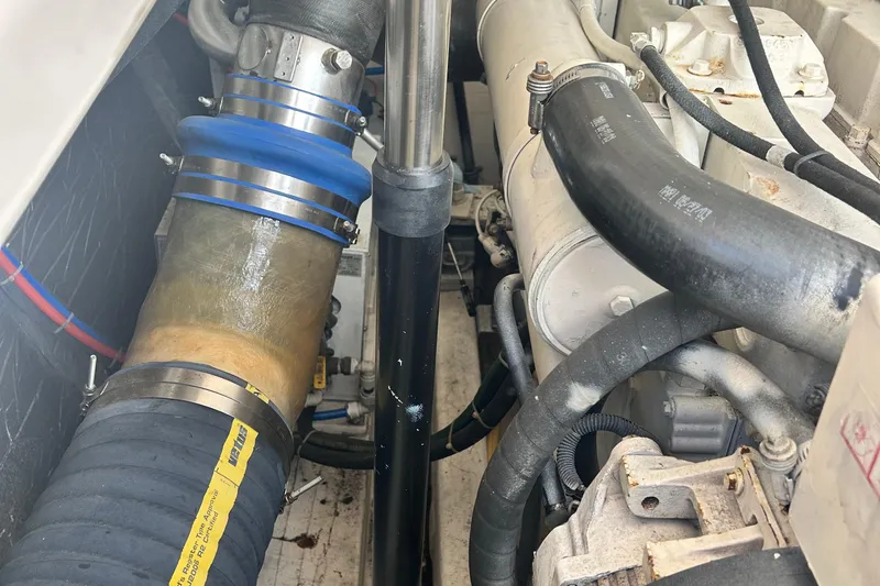 Freedom Yacht Photos Pics Engine compartment of 2004 Tiara Yachts 36 Sovran, showcasing hoses and mechanical components.