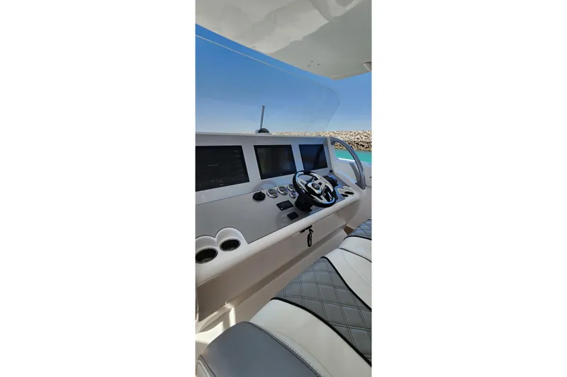  Yacht Photos Pics 2017 Midnight Express 43 Open boat cockpit with modern controls and steering wheel.