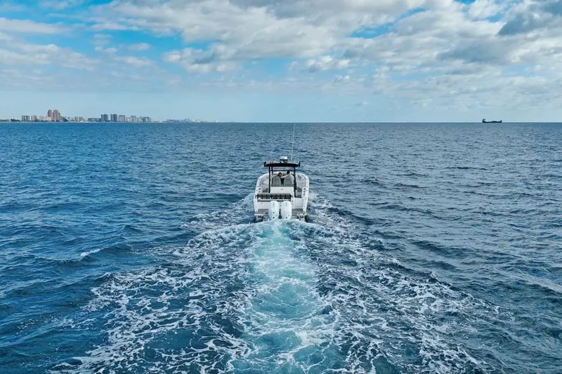  Yacht Photos Pics SeaWell 345XL boat cruising on open ocean, 2025 model, with city skyline in background.
