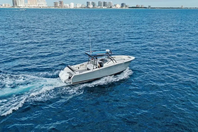  Yacht Photos Pics A 2025 SeaWell 345XL boat cruising on open blue water near a city skyline.