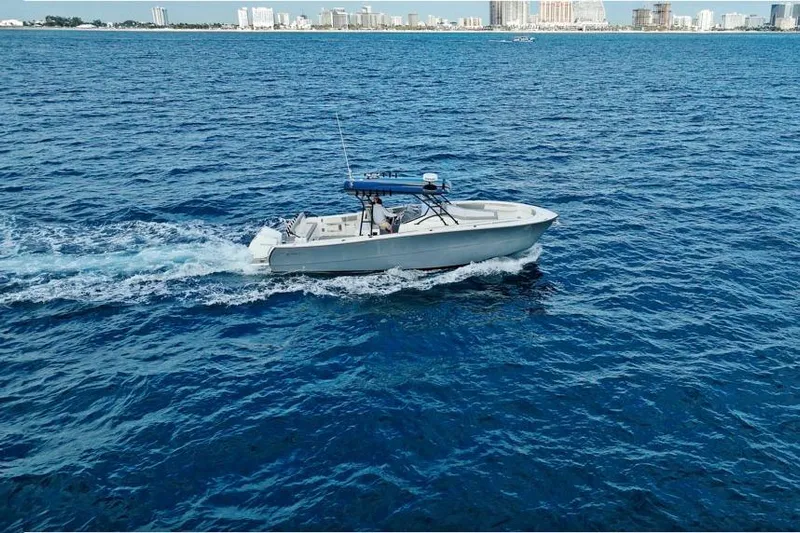  Yacht Photos Pics A 2025 SeaWell 345XL boat cruising on open blue water near a city skyline.