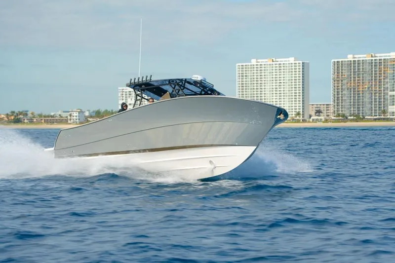  Yacht Photos Pics SeaWell 345XL 2025 boat cruising on ocean near city skyline.