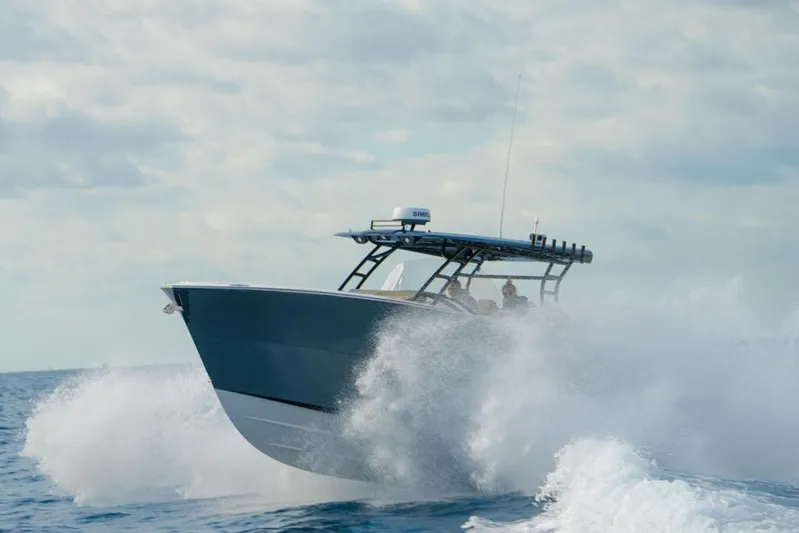  Yacht Photos Pics 2025 SeaWell 345XL boat navigating through ocean waves under a cloudy sky.