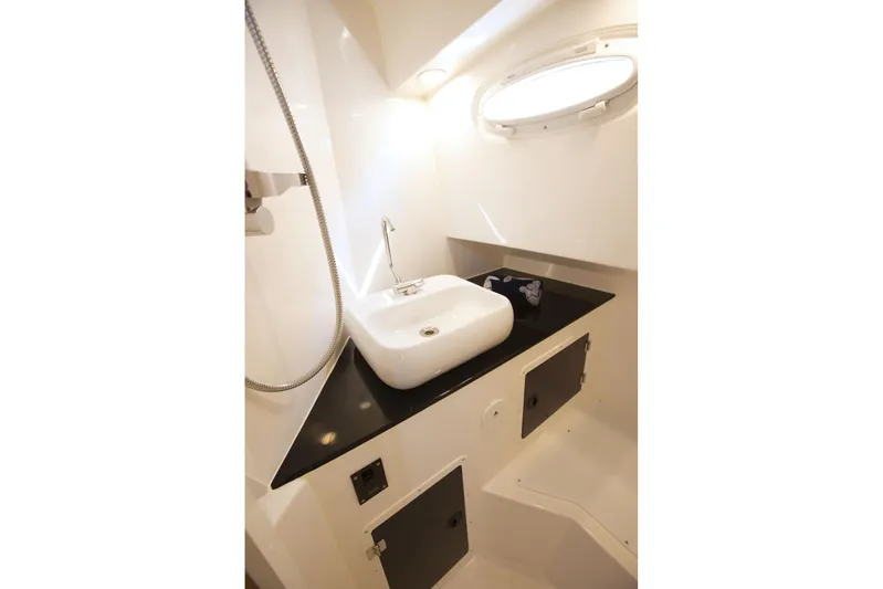  Yacht Photos Pics Modern bathroom interior of SeaWell 345XL yacht, featuring sleek sink and porthole window, 2025 model.