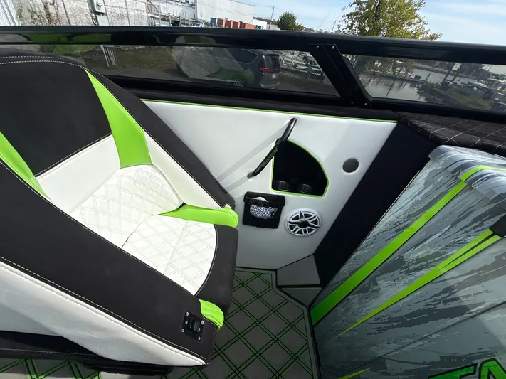  Yacht Photos Pics Interior of a 2000 Fountain Lightning boat with green and white seating.