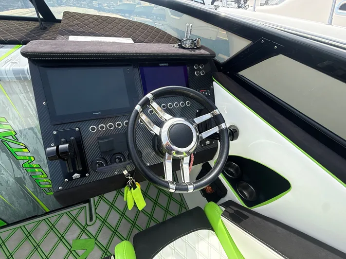  Yacht Photos Pics Steering wheel and dashboard of a 2000 Fountain Lightning boat with modern controls.