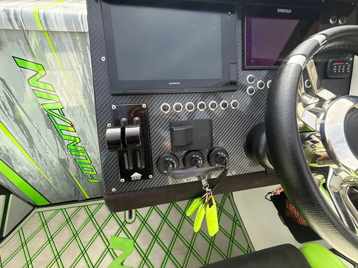  Yacht Photos Pics Dashboard of a 2000 Fountain Lightning boat with modern controls and displays.