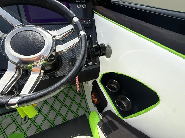  Yacht Photos Pics Steering wheel and interior of 2000 Fountain Lightning boat with modern design elements.