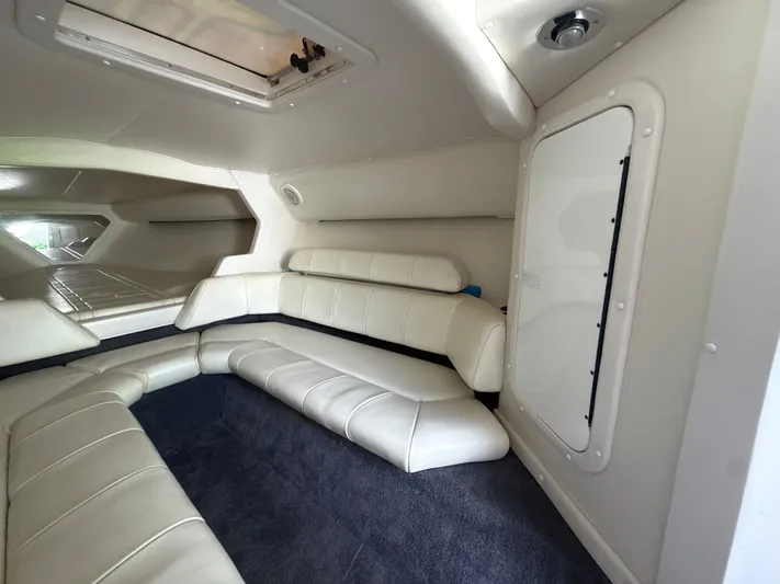  Yacht Photos Pics Interior of 2000 Fountain Lightning boat with white leather seating and carpeted floor.