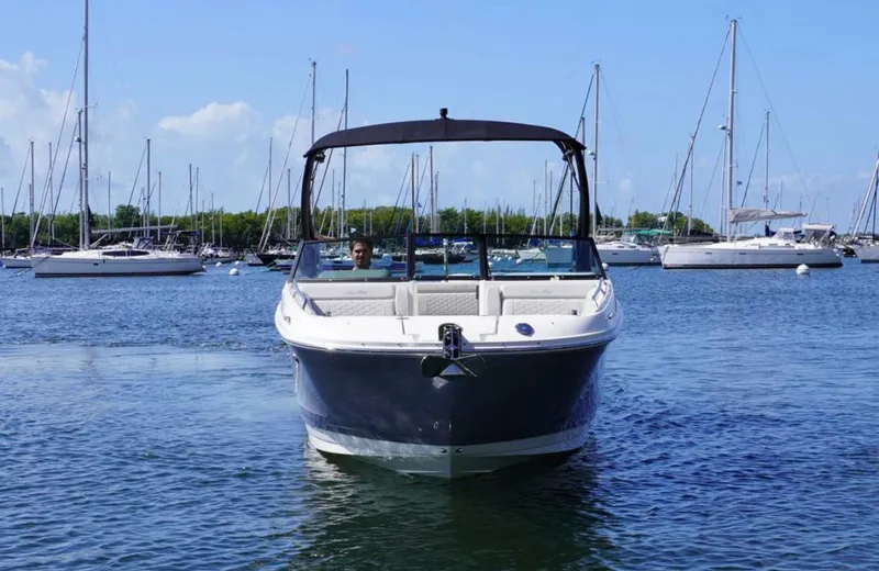  Yacht Photos Pics 2022 Sea Ray SDX 270 Outboard boat on calm water, surrounded by sailboats.