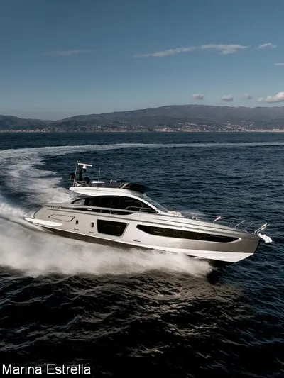  Yacht Photos Pics 2025 Azimut S7 yacht cruising on open water, with scenic coastal backdrop.