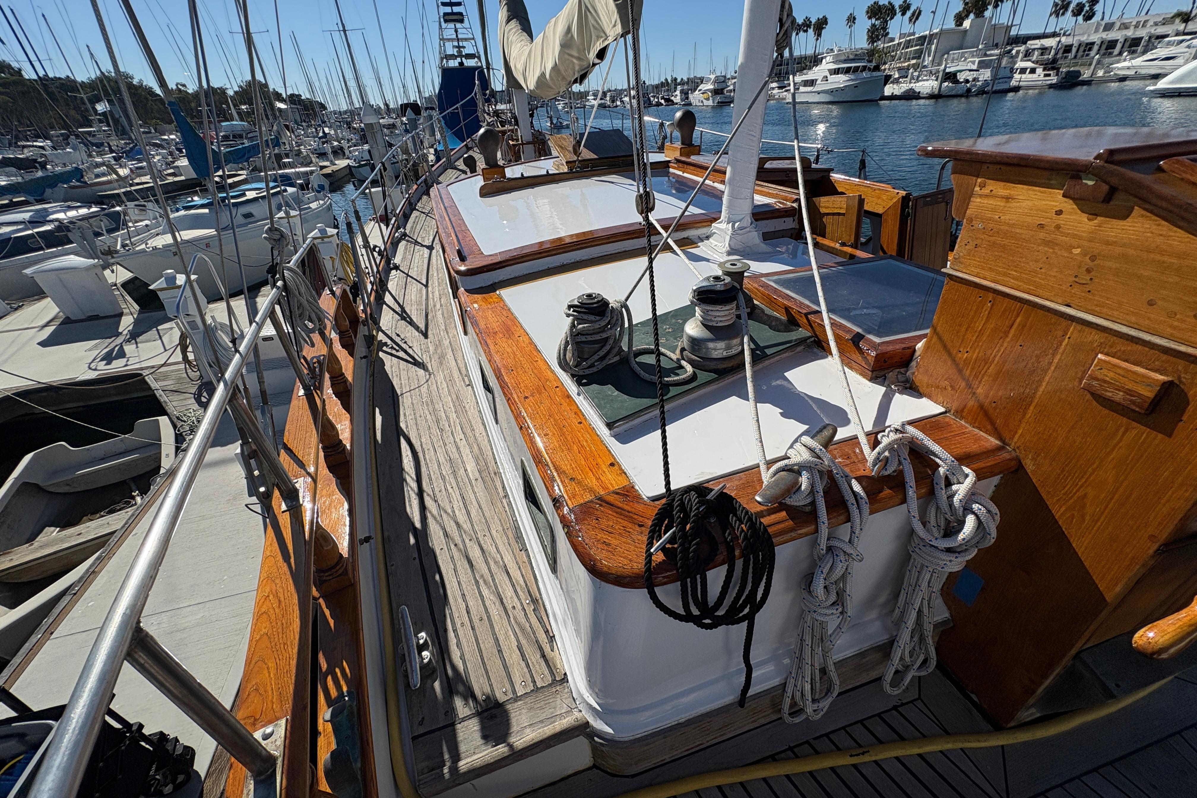 1979 Formosa 51 sailboat deck with ropes and winches in a marina setting.