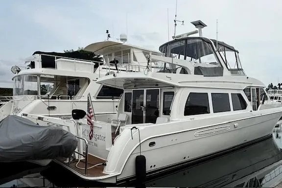  Yacht Photos Pics 2007 Navigator 58 yacht docked at marina, featuring sleek design and spacious upper deck.