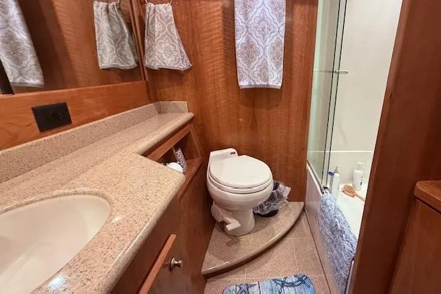  Yacht Photos Pics Luxurious bathroom in 2007 Navigator 58 yacht with elegant wood finish and modern amenities.