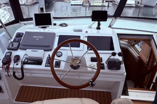  Yacht Photos Pics Cockpit of 2007 Navigator 58 yacht with advanced navigation equipment and wooden steering wheel.