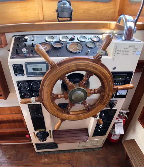  Yacht Photos Pics 1989 Nordic Tug 32 helm with wooden wheel and control panel.