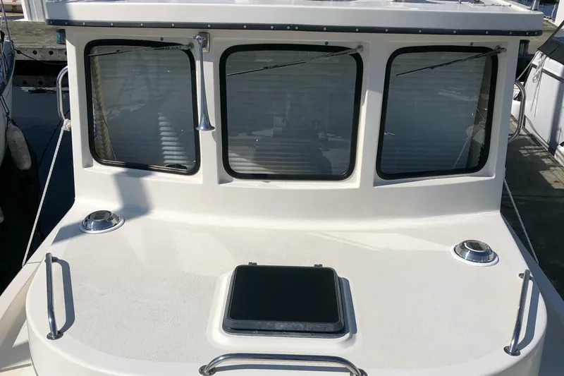  Yacht Photos Pics 1989 Nordic Tug 32 boat with three windows and deck hatch.