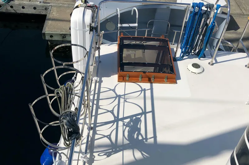  Yacht Photos Pics 1989 Nordic Tug 32 deck with hatch, ropes, and dockside view.