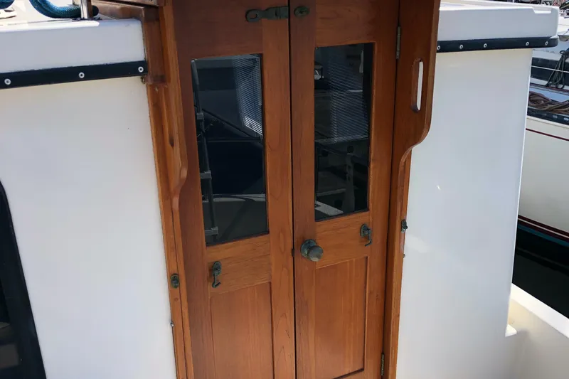  Yacht Photos Pics Wooden doors on a 1989 Nordic Tug 32 boat, featuring glass panels.