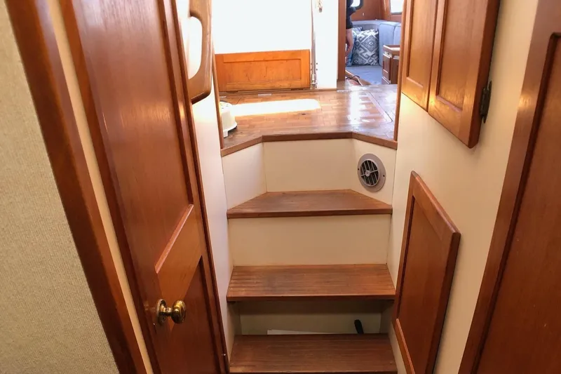  Yacht Photos Pics Staircase inside 1989 Nordic Tug 32, featuring wooden steps and paneling.