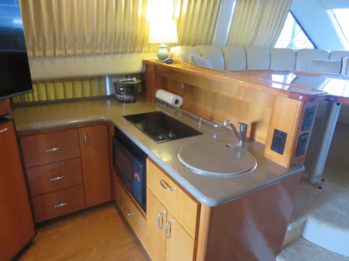 38 Special Yacht Photos Pics 2006 Carver 38 Super Sport yacht kitchen with stove, sink, and microwave.