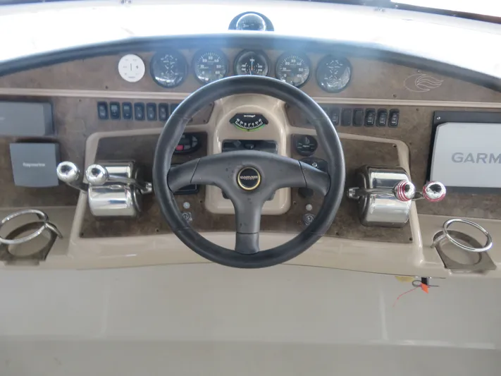 38 Special Yacht Photos Pics 2006 Carver 38 Super Sport helm with steering wheel, gauges, and navigation equipment.