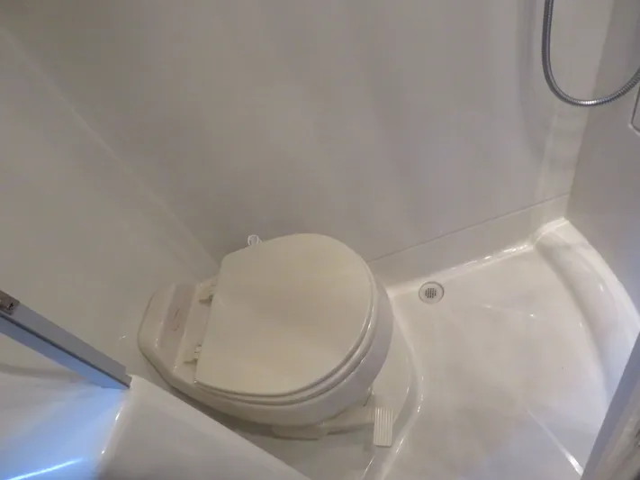 38 Special Yacht Photos Pics Compact bathroom with toilet and shower in 2006 Carver 38 Super Sport yacht.