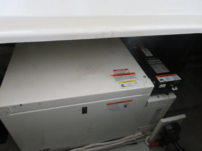 38 Special Yacht Photos Pics Engine compartment of a 2006 Carver 38 Super Sport boat, featuring a generator system.