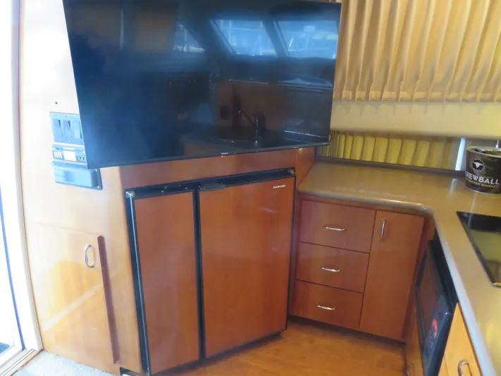 38 Special Yacht Photos Pics Interior of 2006 Carver 38 Super Sport yacht with TV and kitchenette.