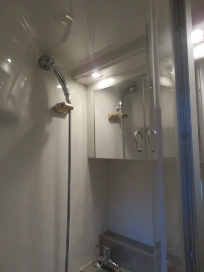 38 Special Yacht Photos Pics Bathroom interior of 2006 Carver 38 Super Sport yacht with shower and mirrored cabinet.