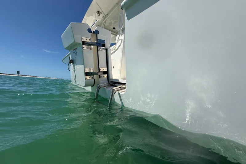  Yacht Photos Pics 2024 SeaVee 390Z boat in water, showcasing rear ladder and hull design.