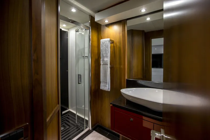 P'ocean Yacht Photos Pics Luxurious bathroom in 2009 Sunseeker Predator 84 yacht with modern fixtures and wood paneling.