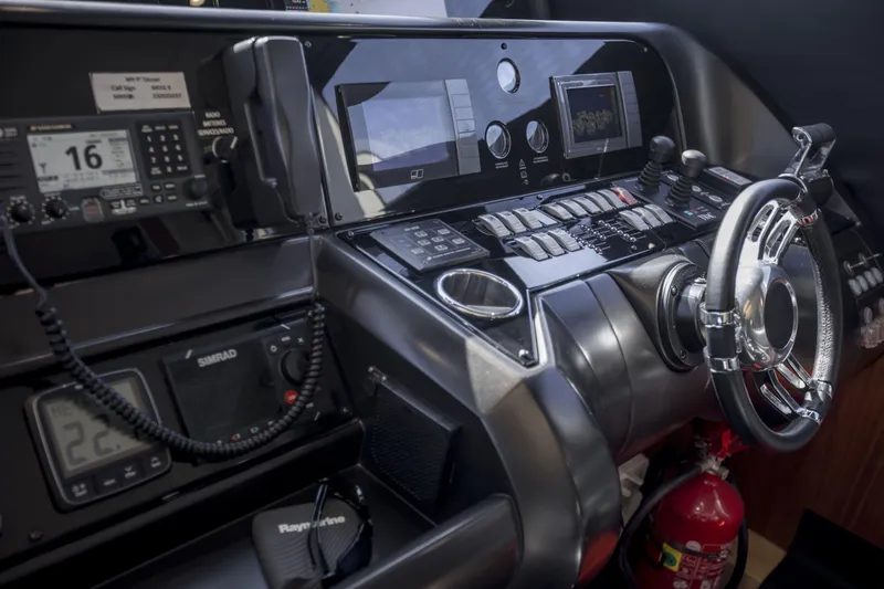 P'ocean Yacht Photos Pics Control panel of 2009 Sunseeker Predator 84 yacht with navigation instruments and steering wheel.