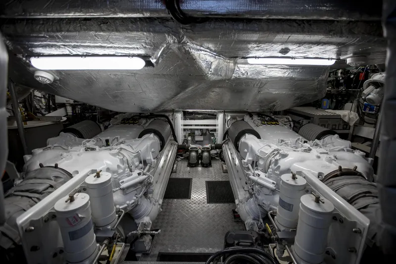 P'ocean Yacht Photos Pics Engine room of 2009 Sunseeker Predator 84 yacht, featuring dual engines and metallic surfaces.