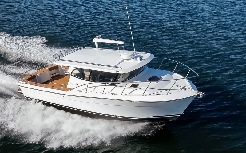  Yacht Photos Pics 2025 Ocean Sport Roamer boat cruising on open water, showcasing sleek design and performance.