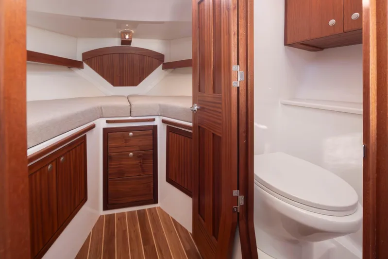  Yacht Photos Pics Luxurious 2025 Ocean Sport Roamer boat interior with wooden cabinetry and modern amenities.