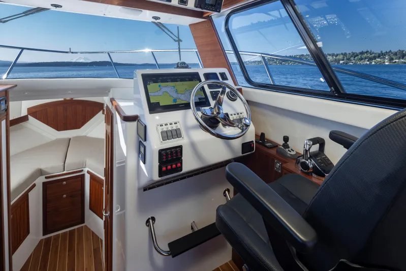  Yacht Photos Pics 2025 Ocean Sport Roamer boat interior with navigation system and steering wheel.