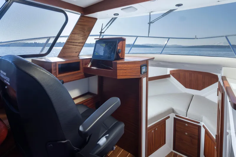  Yacht Photos Pics Interior of 2025 Ocean Sport Roamer boat with wood accents and navigation equipment.