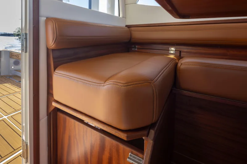  Yacht Photos Pics Luxurious leather seating on 2025 Ocean Sport Roamer boat, featuring elegant wood accents.