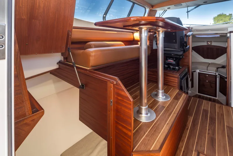  Yacht Photos Pics Interior of 2025 Ocean Sport Roamer boat with wood finish and seating area.