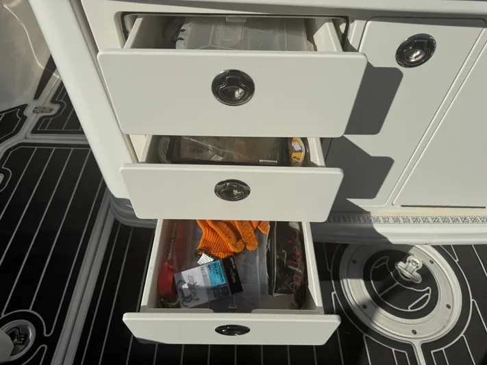  Yacht Photos Pics Storage drawers on a 2012 Boston Whaler 370 Outrage boat, containing various items.
