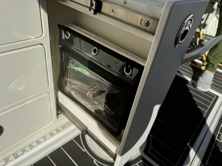  Yacht Photos Pics 2012 Boston Whaler 370 Outrage storage compartment with built-in organizer and measuring ruler.