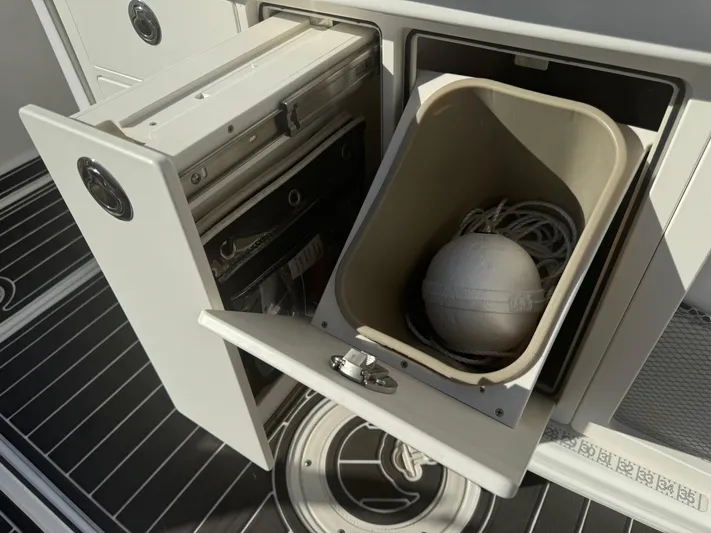  Yacht Photos Pics 2012 Boston Whaler 370 Outrage storage compartment with marine equipment inside.