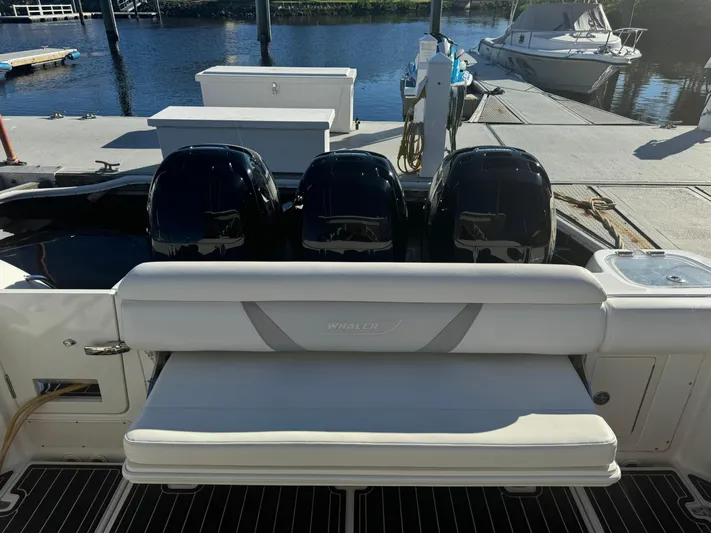  Yacht Photos Pics 2012 Boston Whaler 370 Outrage with triple outboard engines at dock.